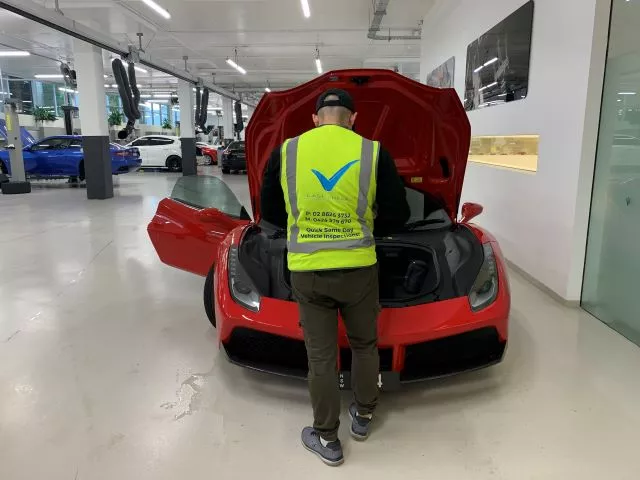 Last Check Inspector Inspecting A Red Ferrari Pre Purchase